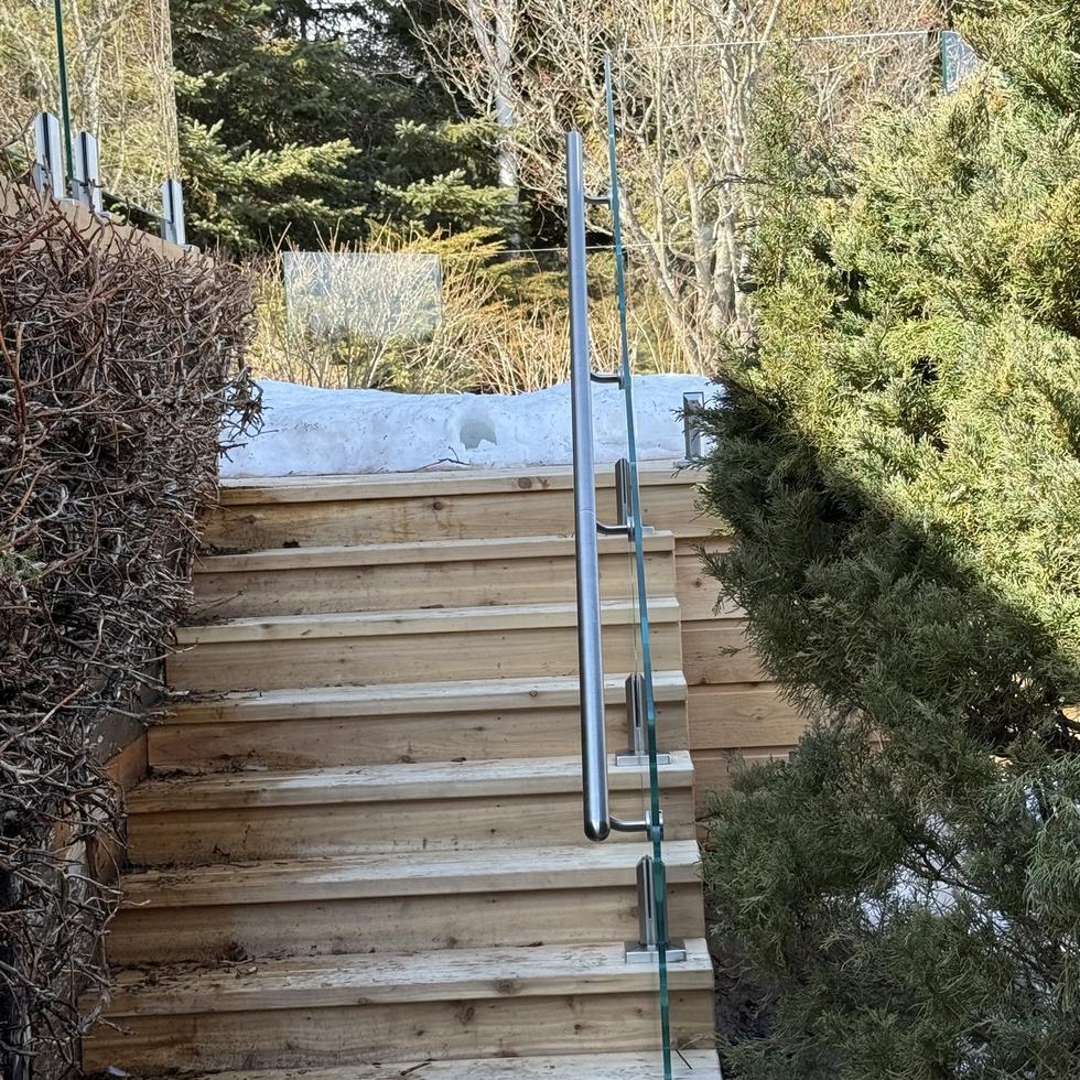 Stairs rebuilt in cedar with glass railing after