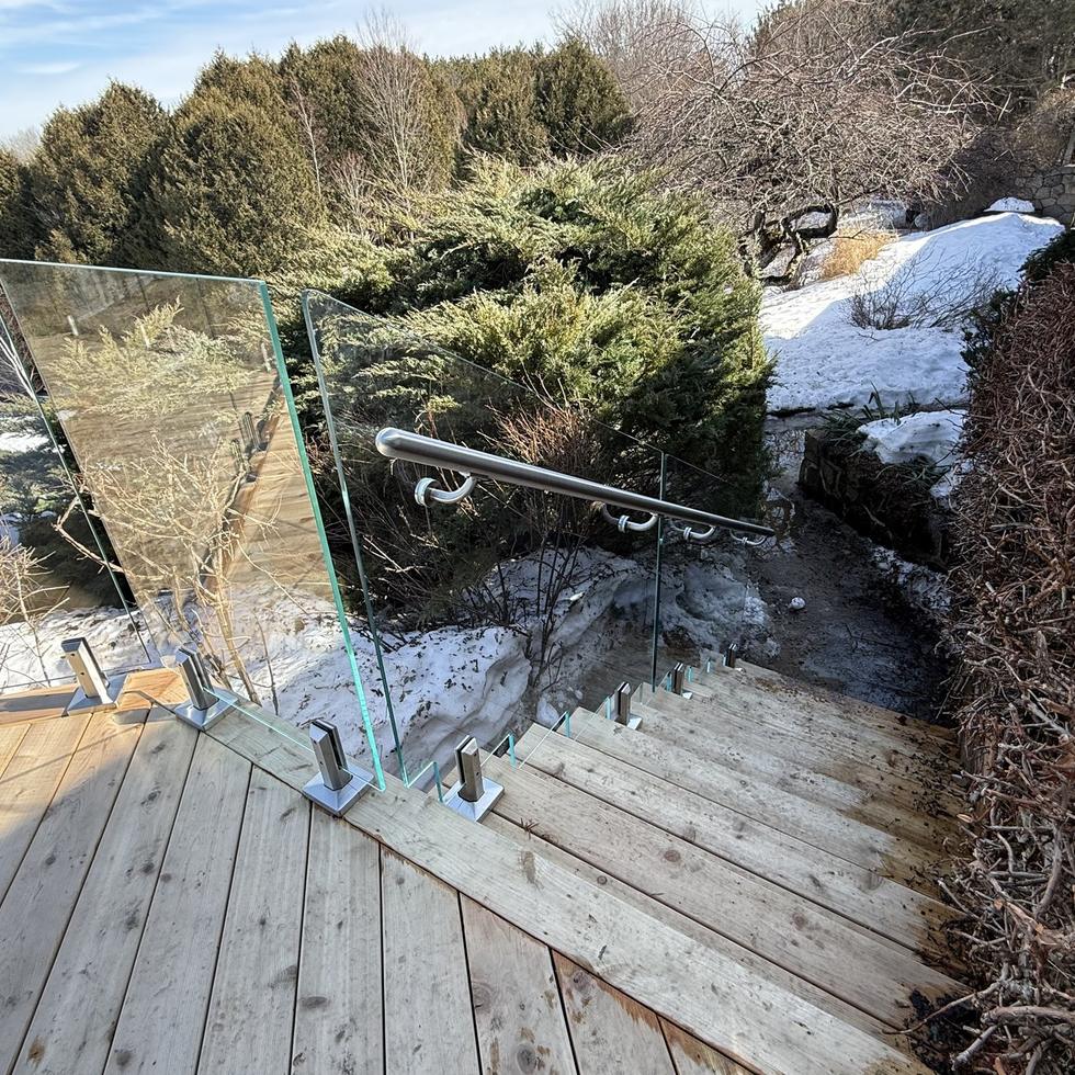Deck rebuilt with glass railing after
