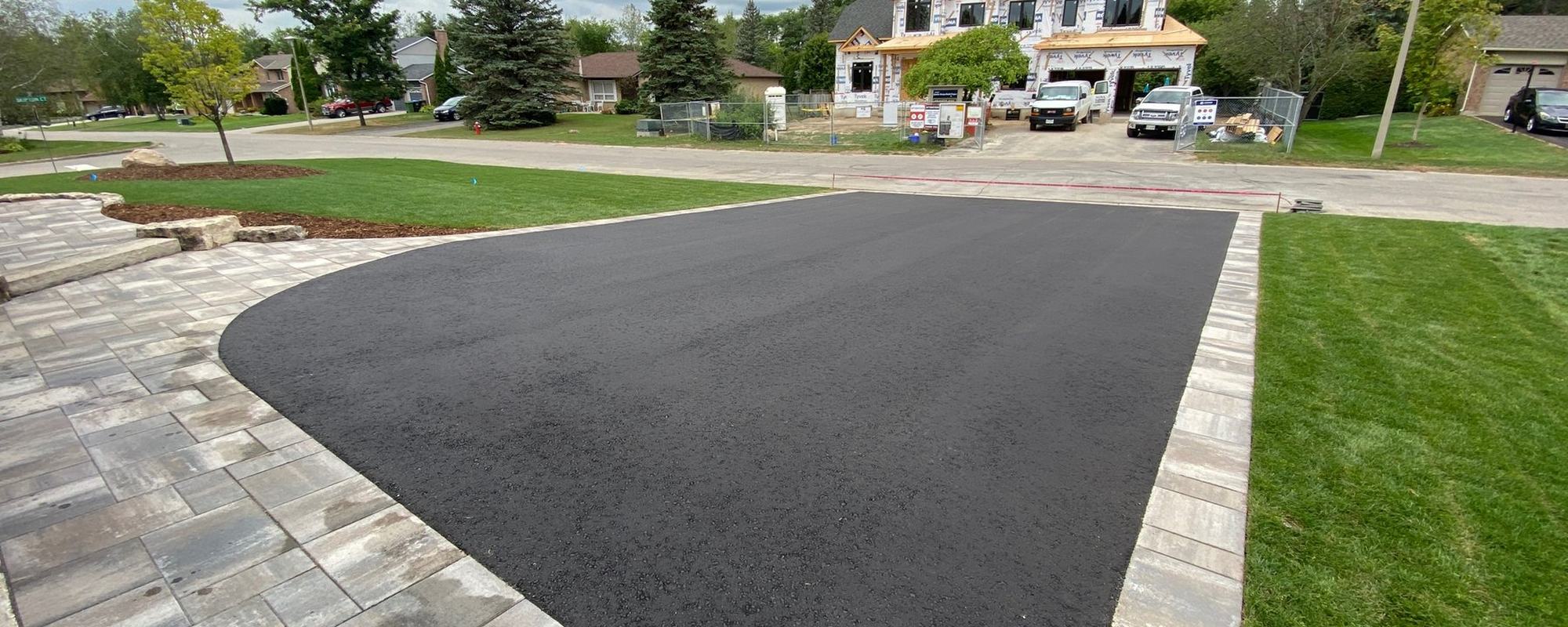 Driveway and interlock apron leading to a home