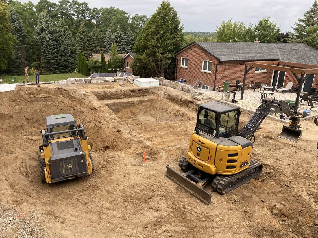 Excavator and dozer working a foundation dig