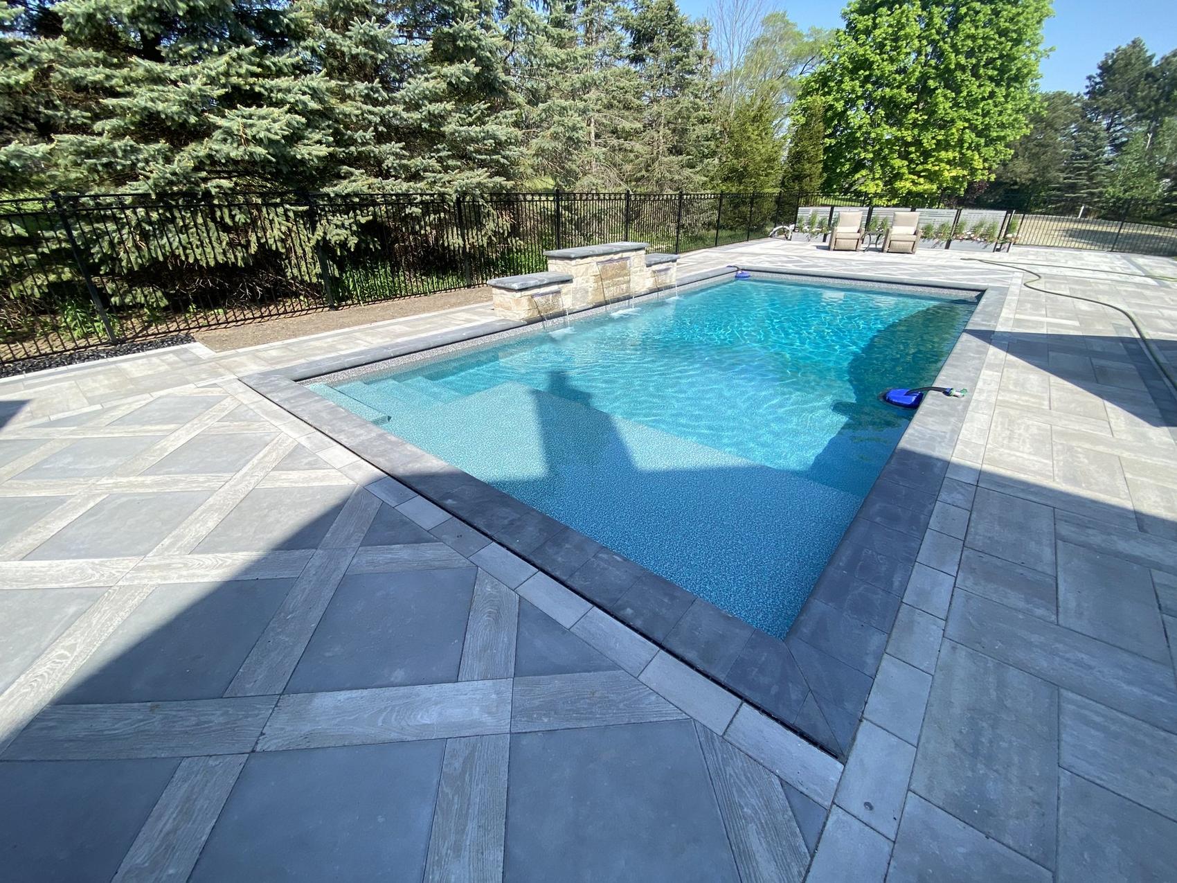 Finished pool and natural stone patio built by River Ridge