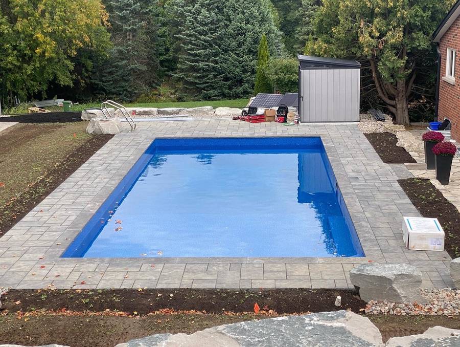Pool with paver deck and shed