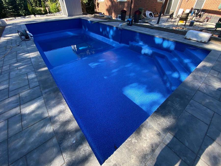 Pool with dark liner and coping