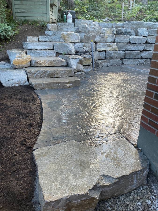 Flagstone walkway beside a stone wall