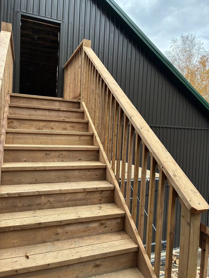 Cedar stairs and railing on a steel clad building