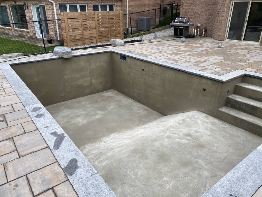 Concrete pool shell with stone coping