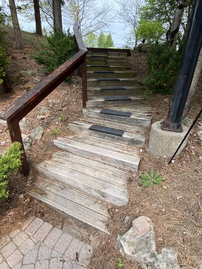Stone steps with handrail on a slope
