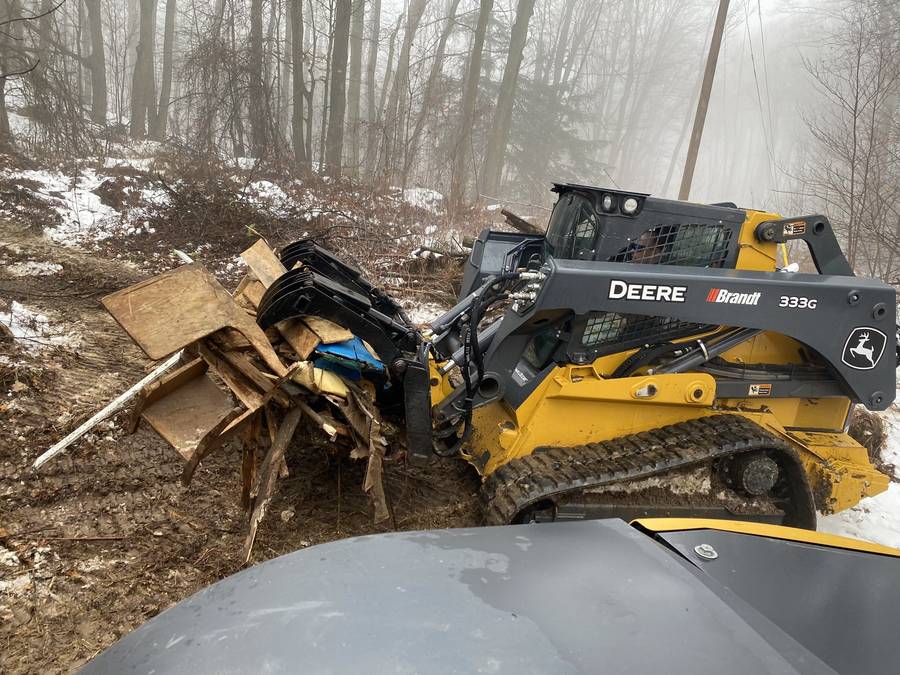 Skid steer clearing debris