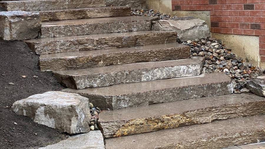 Natural stone entrance steps with river rock