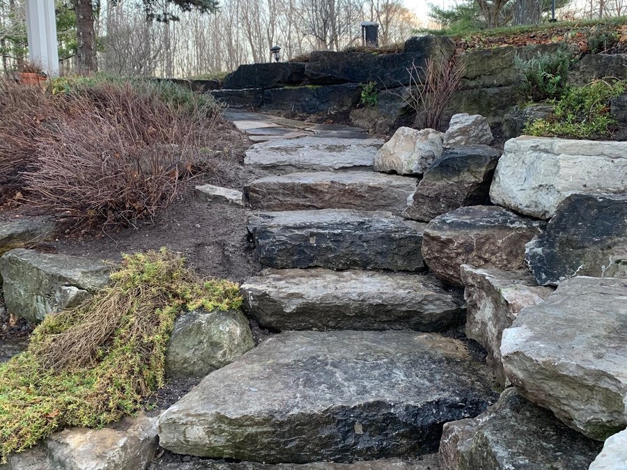 Natural stone slab steps set through a planted bank